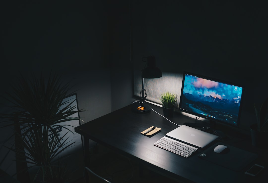 Ergonomically arranged home office setup with monitor at eye level, desktop accessories, and comfortable workspace.