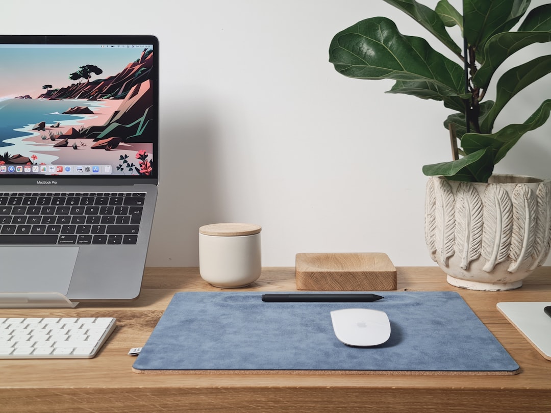 A minimalist leather desk pad covering a dark desk surface with a keyboard and mouse