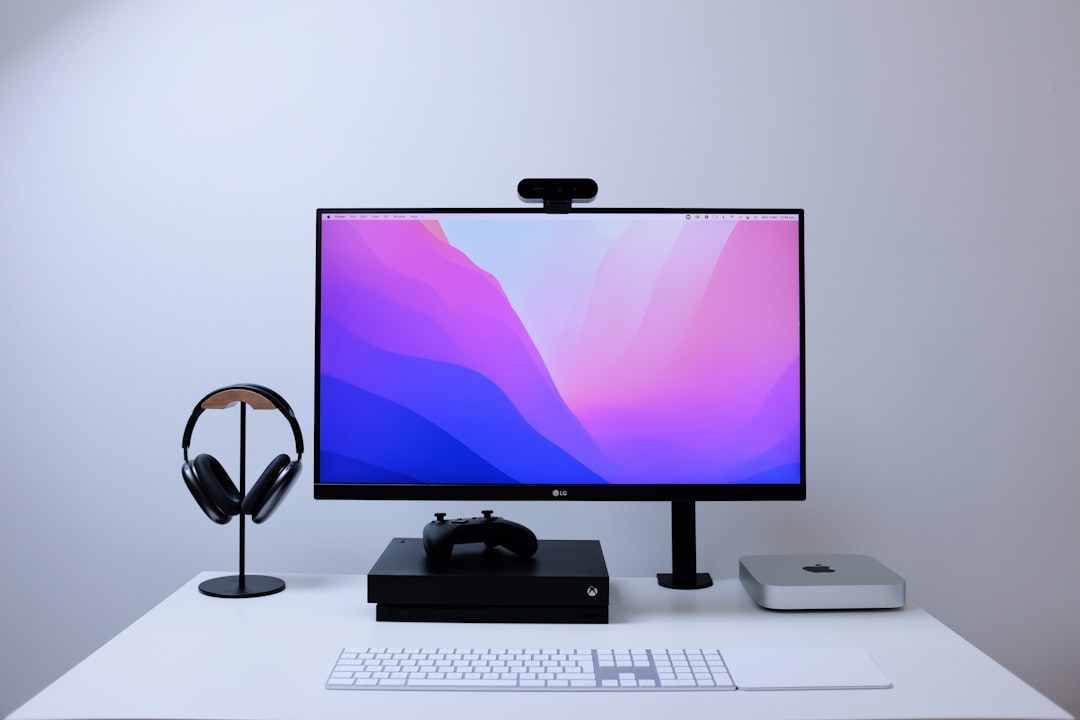 Dual computer monitors mounted on a heavy-duty desk clamp arm above an organized desk