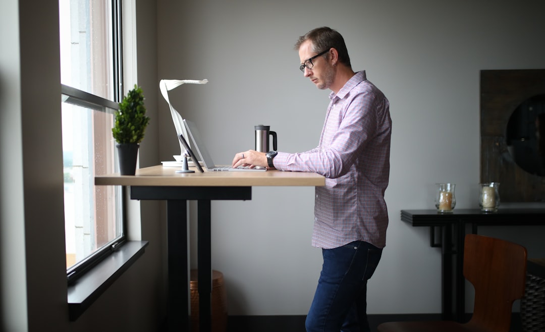 A motorized standing desk frame with dual motor legs