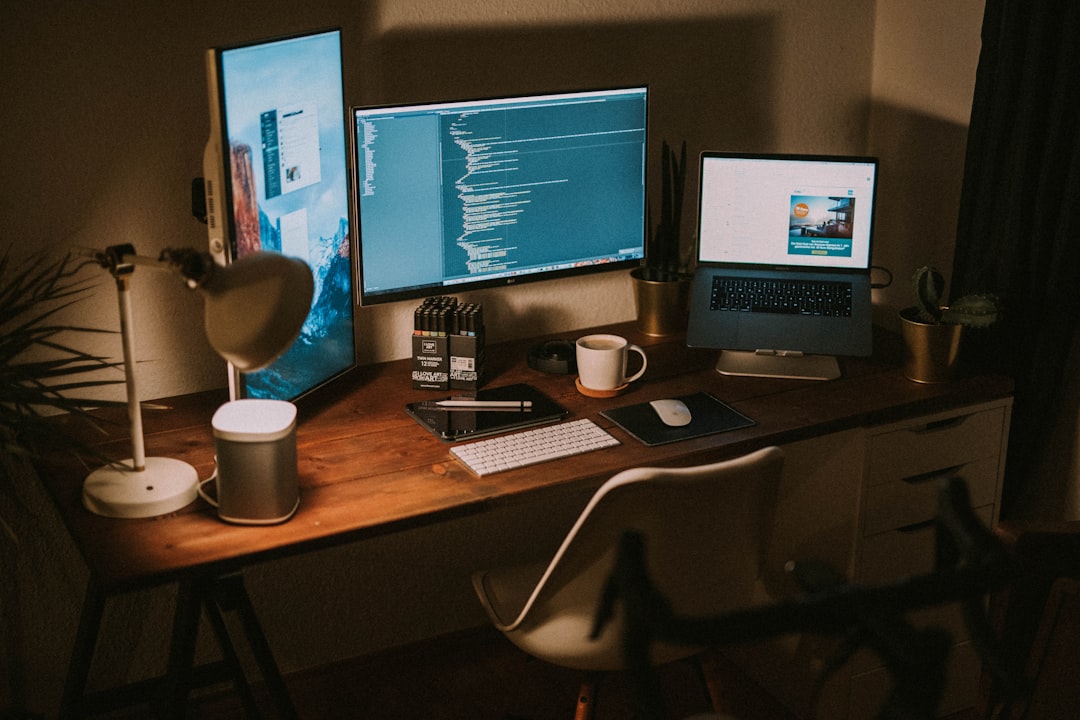 Dual monitor desk setup showing a primary centered screen and secondary side screen angled inward