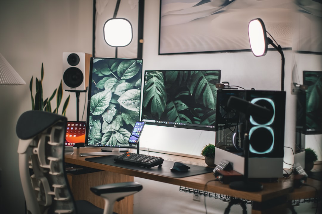 Minimalist office workstation with dual monitors mounted on arms with invisible routed cables