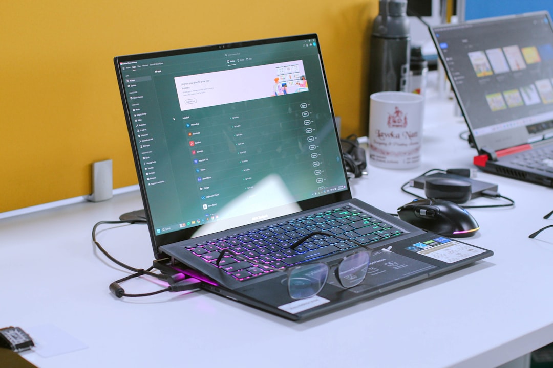Diagram illustrating a KVM switch connecting two laptops to a single monitor and shared keyboard mouse peripherals