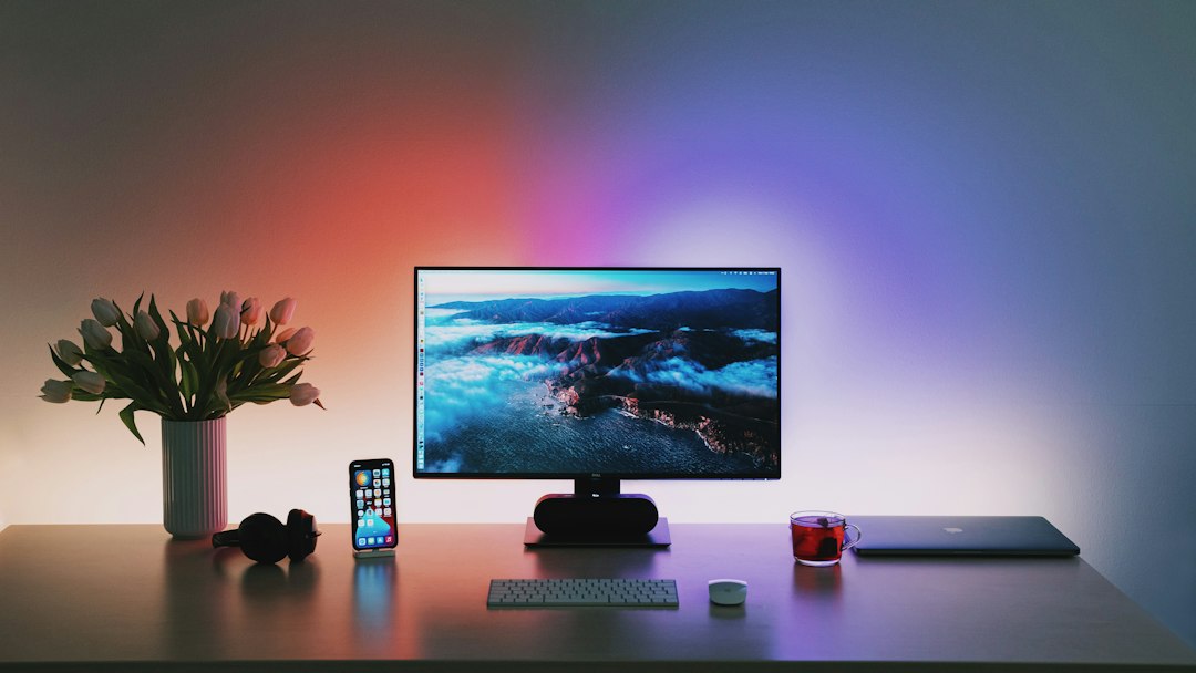 Smart home office desk setup with illuminated monitor light bar and clean workspace