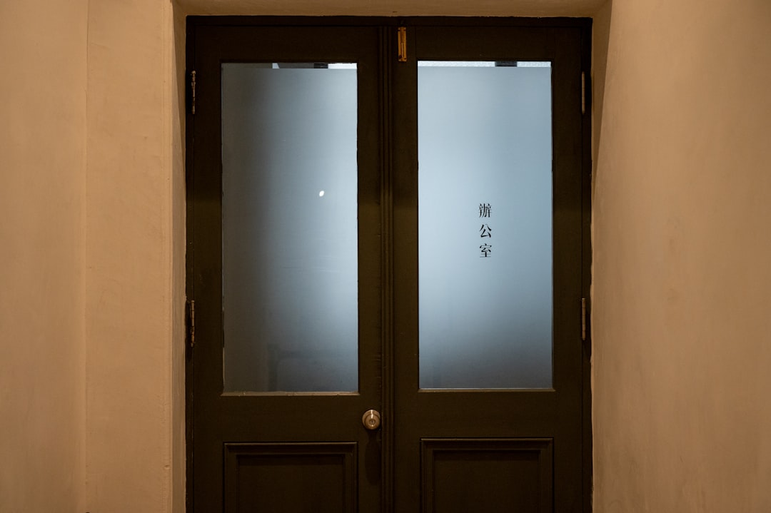 Red LED smart status light mounted outside a modern home office door signaling an active meeting