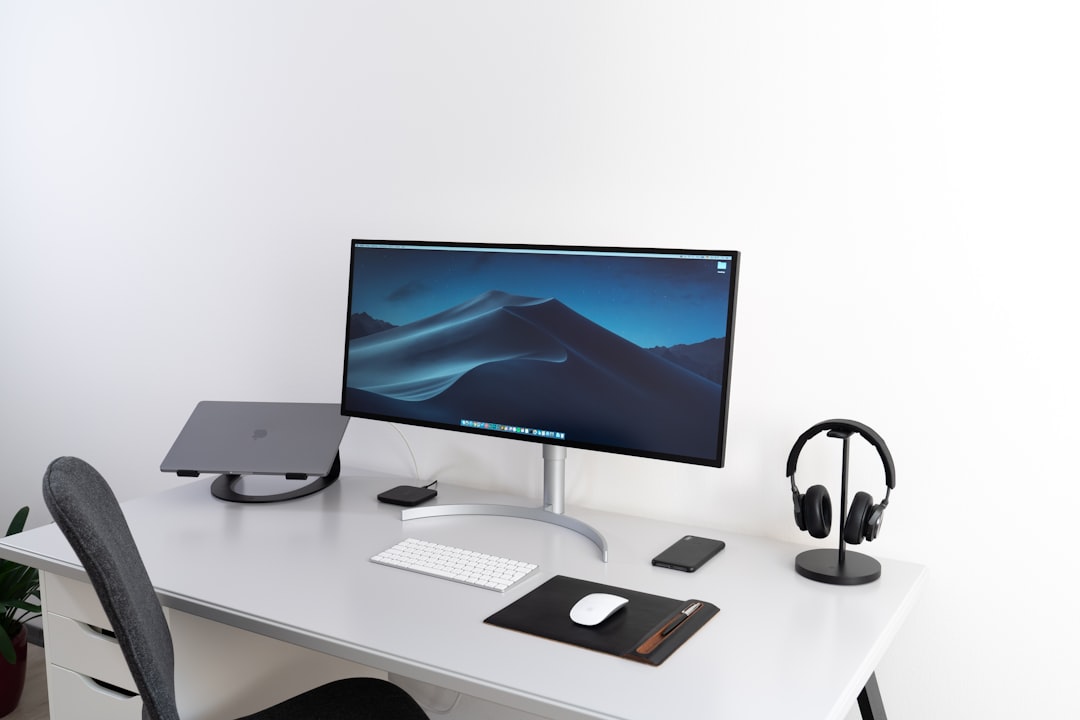 Sleek metallic Thunderbolt 4 dock sitting on a minimalist desk connected to peripheral wires