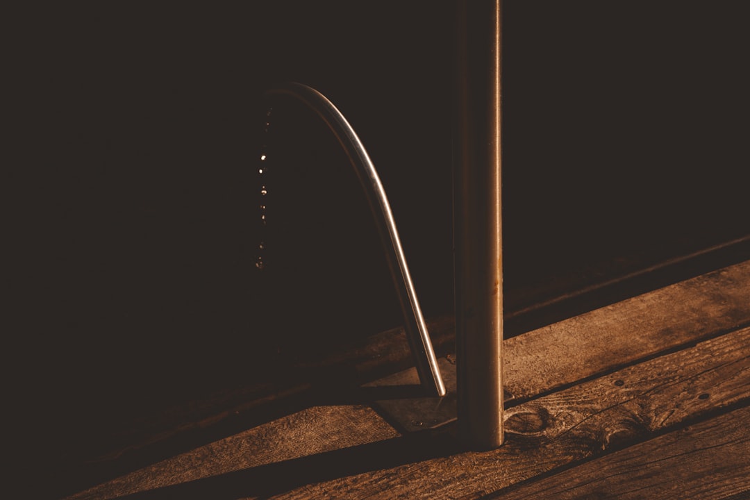Detailed view of a silicone multi-fin door sweep mounted to the bottom edge of an interior door against the floor
